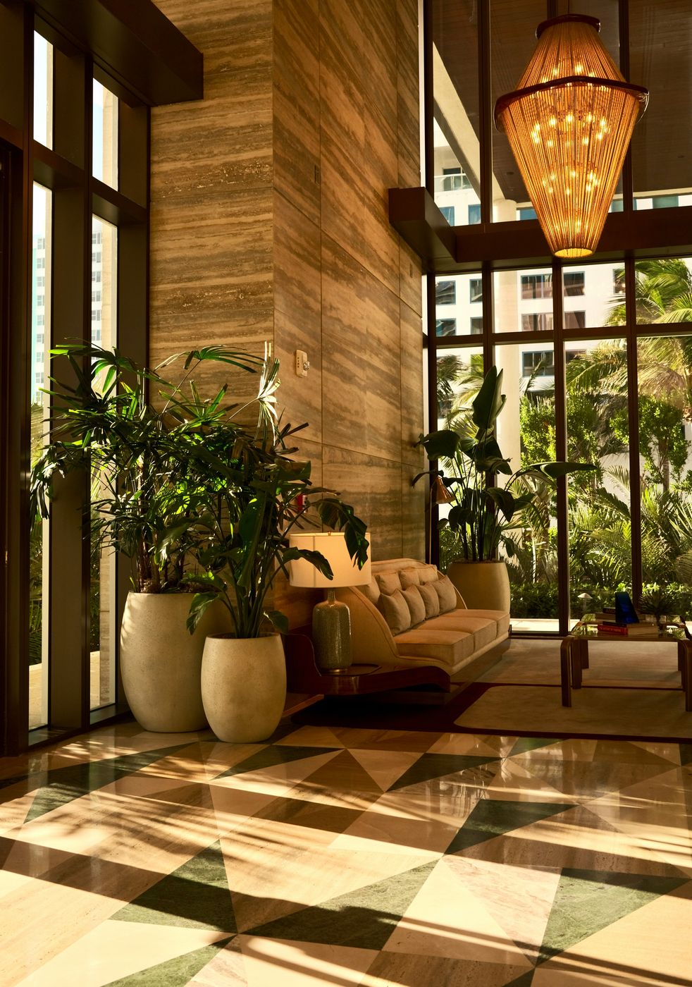 Hotel lobby with timber columns and a brass pendant light
