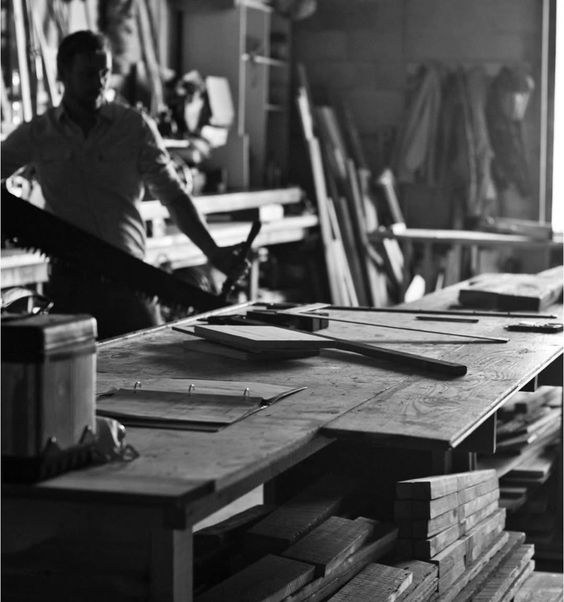 Carpenter cutting timber in a joinery workshop